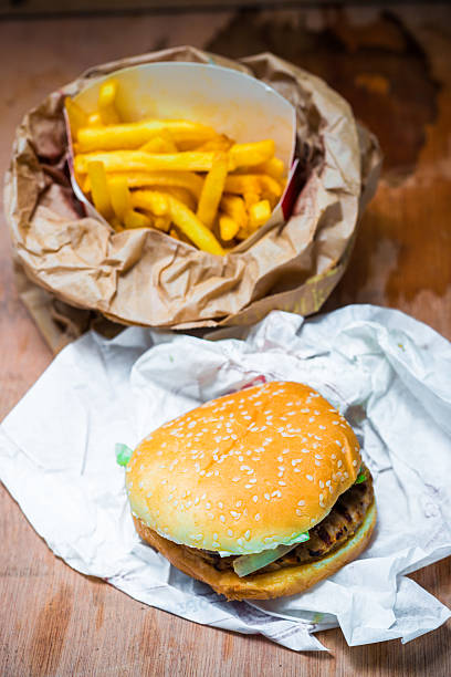 istock Hamburger with fries on a wooden table 483588284