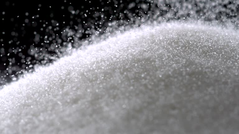 Pile of sugar on black background, Slow Motion