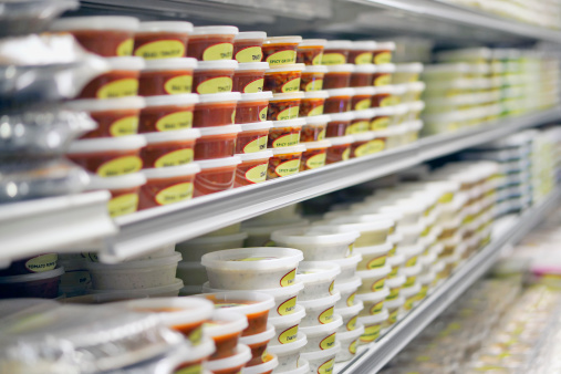 Dips on refrigerated takeout store shelves. Labels are generic, unbranded descriptive of contents such as \