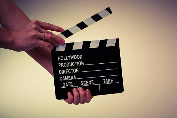 istock Movie flapper in woman´s hands on white background 483590125