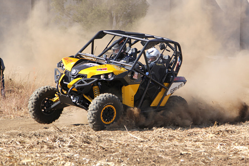 Koster, North West Province, South Africa - July 11, 2015: Africa-Offroad Racing Rally.  Custom twin seater rally buggy kicking up trail of dust on sand track during rally race.