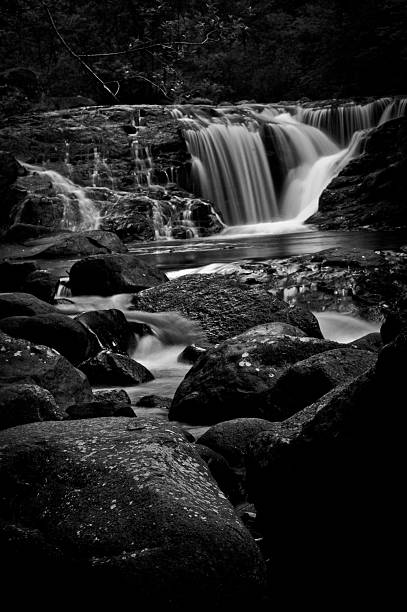 istock Black and white waterfall and rocky creek 483595940