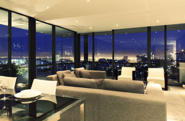 istock Illuminated modern living room overlooking city 483596445