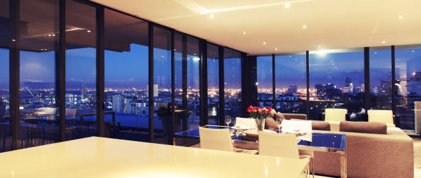 istock Illuminated modern living room overlooking city 483596449