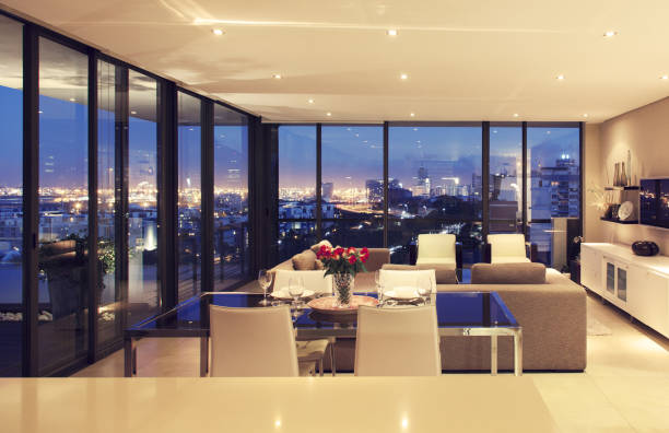 istock Illuminated modern living room overlooking city 483596459