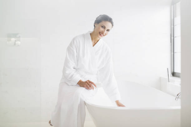 istock Portrait of smiling woman in bathrobe preparing bath 483599113