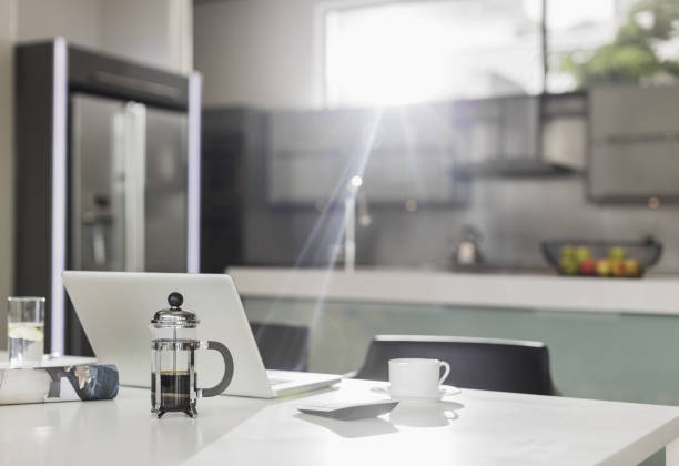 istock Morning sun shining on laptop in kitchen 483599217