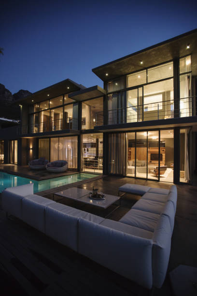 istock Sectional sofa at poolside of luxury house at night 483599341