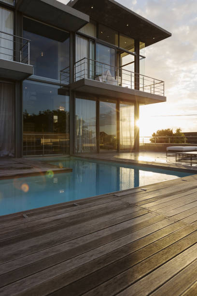 istock Sun behind luxury house with swimming pool 483599465