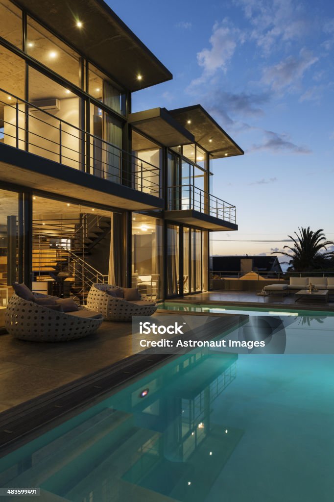 Luxury house with swimming pool illuminated at night  Architecture Stock Photo