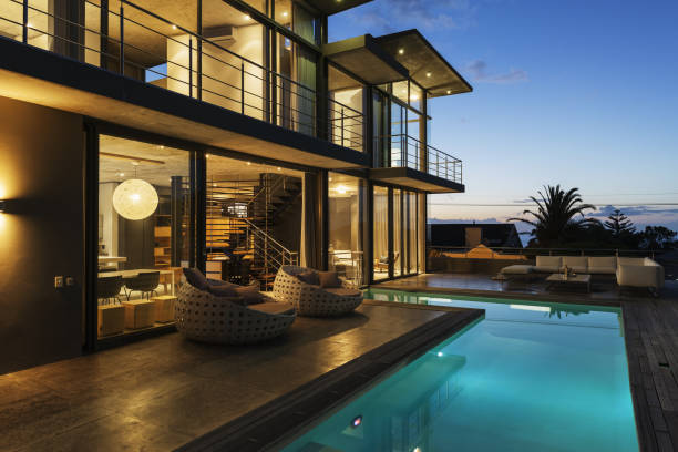 istock Luxury house with swimming pool illuminated at night 483599493