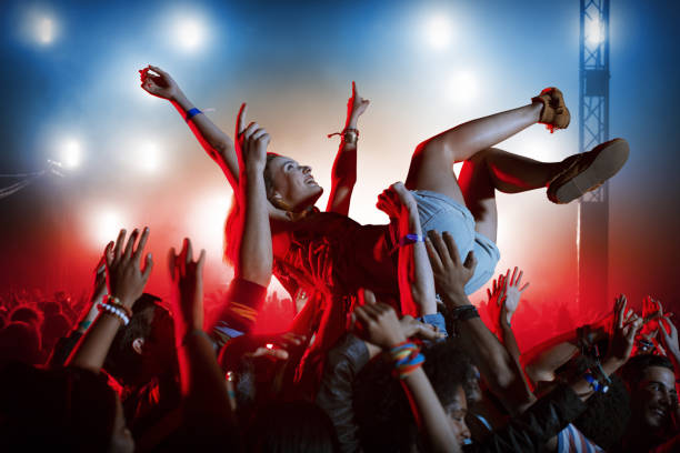 istock Man crowd surfing at music festival 483599497