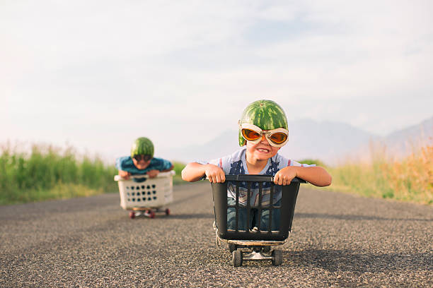 Young Boys Racing Wearing Watermelon Helmets