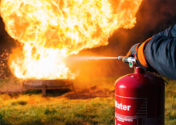 istock Fighting fire with a water extinguisher 483602854