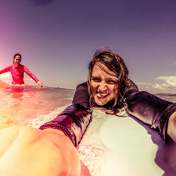 istock Surfer girls making a selfie 483602952