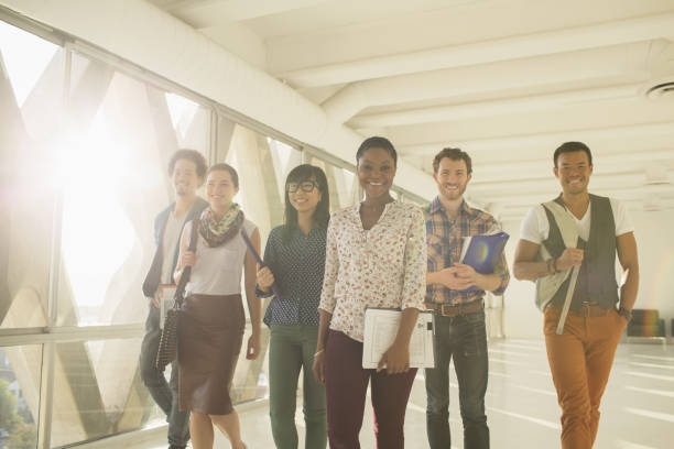 istock Confident creative business people walking in sunny corridor 483605123