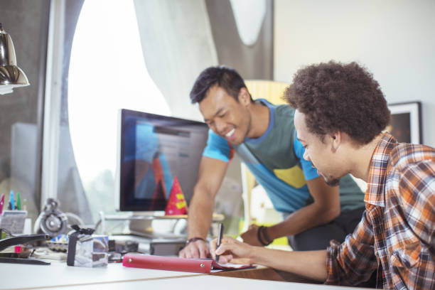 istock Casual businessmen reviewing paperwork in office 483605655