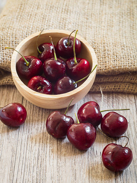 istock Fresh red cherries on wooden table 483606860