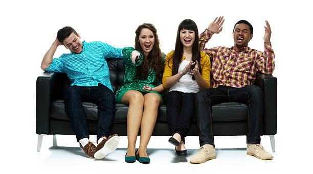 istock Four friends sitting on couch and laughing 483607178