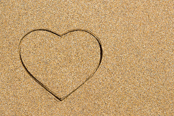 istock Heart shape engraved in a wet sandy beach 483607274