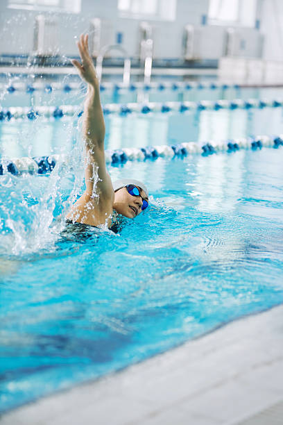istock Young girl in goggles swimming front crawl stroke style 483611486