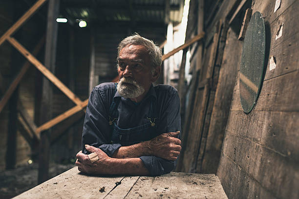 istock Lonely farmer sitting inside a wooden barn 483611792