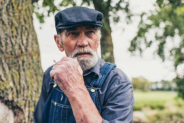 istock Senior country farmer standing smoking 483611832