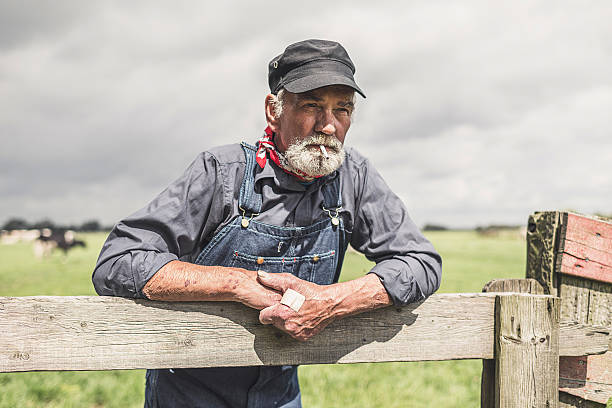 istock Old grizzled farmer standing smoking 483611864