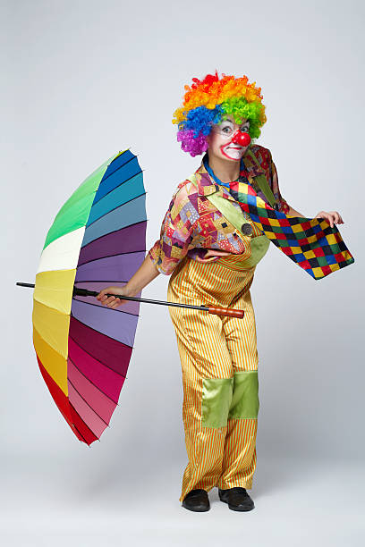 istock clown with colorful umbrella on white 483612644