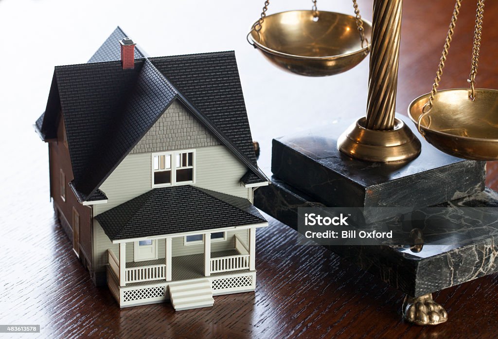 House and Scales of Justice House and Scales of Justice on wood table. Concept mortgage, foreclosure, refinance Law Stock Photo