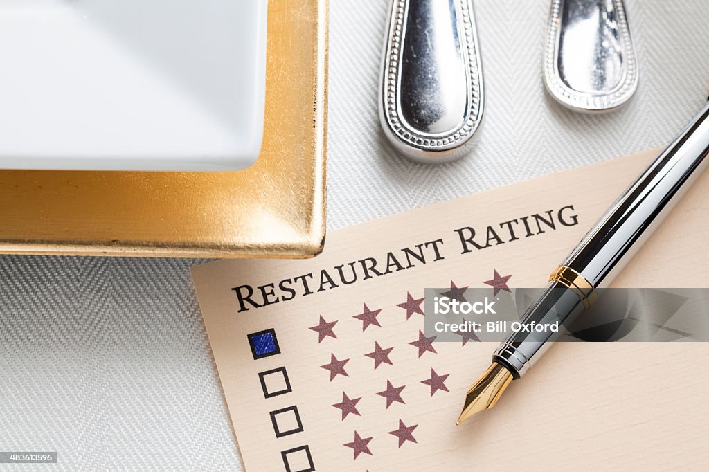Restaurant Rating Restaurant Rating concept with pen and table setting. Food Stock Photo