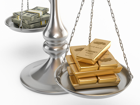 Gold ingots and dollars standing on the sides of a balanced scale.