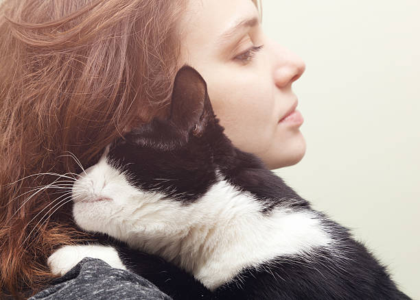 Woman hugging cat siames, love of animals, adoption