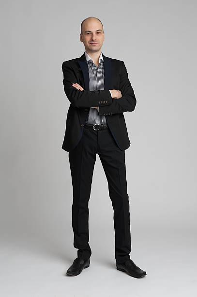 istock smiling confident businessman standing arms crossed 483618621