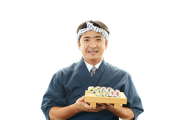 Smiling Japanese chef Smiling Japanese chef with sushi japanese chef stock pictures, royalty-free photos & images