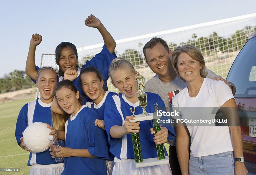 Parents with Daughter's Soccer Team and Trophy Parent Stock Photo