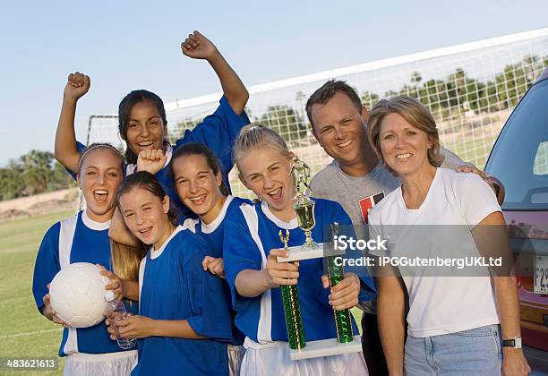 Parents With Daughters Soccer Team And Trophy Stock Photo - Download Image Now - Parent, Teamwork, Teenager