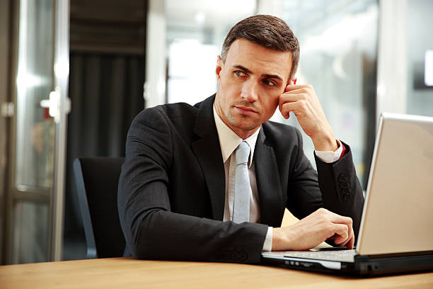 istock businessman sitting with laptop 483626683