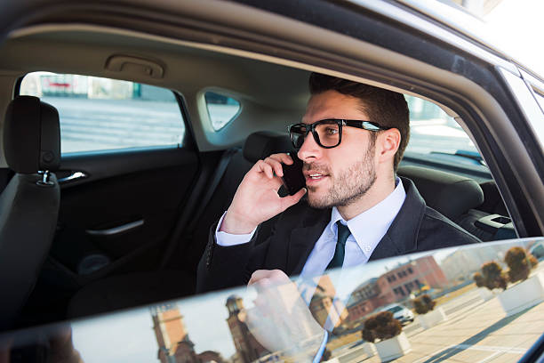 istock Businessman in car talking on cell phone 483627659