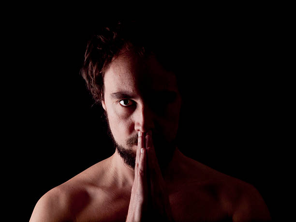 istock Low key image of a bearded man praying 483627975
