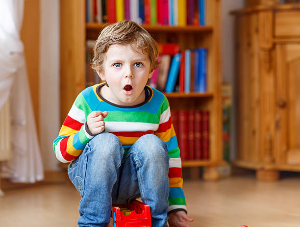 istock Funny blond kid boy shouting and playing, indoors 483629200
