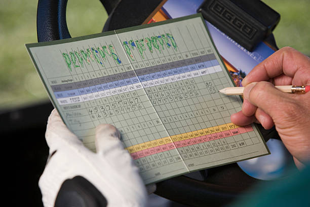 Golfer Marking Score on Scorecard stock photo