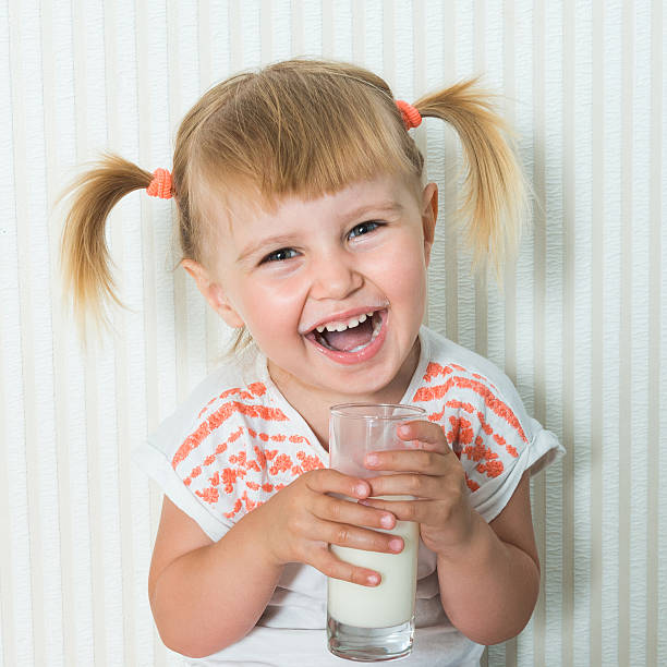 istock happy girl  drink the milk 483629306