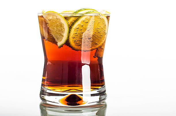 istock Glass of cola with sliced lemon 483629450