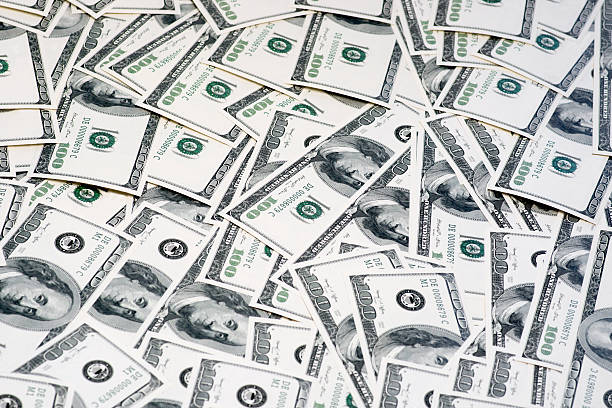 istock One hundred dollars pile as background. 483629626