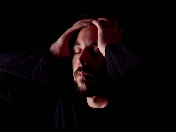 istock Low key image of a bearded man with headache 483629749