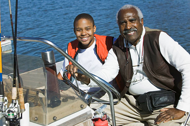 avô com seu neto no barco de pesca - fishing active seniors family senior adult imagens e fotografias de stock