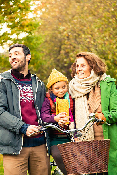 istock Three Generations all together at the park on a bike 483630091