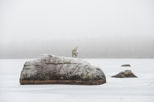 A zen-like rock garden in a frozen lake, at the arctic circle, Lapland, Finland