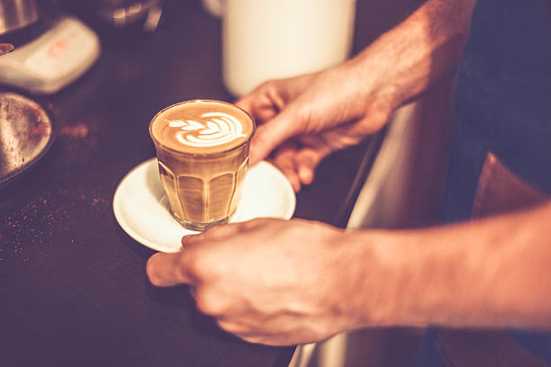 Young barista is making a coffee